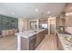 A kitchen features an island with granite countertops and stainless steel appliances at 7665 Serenity Bay Ln # Lot 58, North Las Vegas, NV 89084