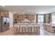 Bright kitchen with stainless steel appliances, island with seating, and an adjacent dining area at 7665 Serenity Bay Ln # Lot 58, North Las Vegas, NV 89084