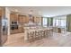 Modern kitchen with stainless steel appliances, a large island, and an adjacent dining area at 7665 Serenity Bay Ln # Lot 58, North Las Vegas, NV 89084