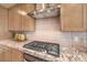 Modern kitchen detail showcasing granite countertops, tile backsplash, and stainless steel range at 7665 Serenity Bay Ln # Lot 58, North Las Vegas, NV 89084
