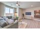 Open living area with cabinets, luxury vinyl plank flooring, large window, and plush olive couch at 7665 Serenity Bay Ln # Lot 58, North Las Vegas, NV 89084
