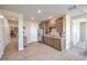 Open living area with cabinets, granite counters, luxury vinyl plank flooring, and stainless refrigerator at 7665 Serenity Bay Ln # Lot 58, North Las Vegas, NV 89084
