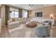 Inviting living room with a large sectional sofa and accent chairs with natural light at 7665 Serenity Bay Ln # Lot 58, North Las Vegas, NV 89084