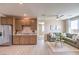 Open living area with cabinets, granite counters, luxury vinyl plank flooring, and an olive green couch at 7665 Serenity Bay Ln # Lot 58, North Las Vegas, NV 89084