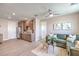 Open living area with cabinets, luxury vinyl plank flooring, large window, and plush olive couch at 7665 Serenity Bay Ln # Lot 58, North Las Vegas, NV 89084
