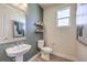 Stylish powder room with modern fixtures, floating shelves, and decorative artwork at 7665 Serenity Bay Ln # Lot 58, North Las Vegas, NV 89084