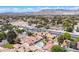 Aerial view of a neighborhood featuring desert landscaping, a pool, and mature trees at 8340 W Fisher Ave, Las Vegas, NV 89149