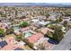 Wide aerial perspective of a home with a pool amidst a dense suburban landscape, highlighting its setting in a residential area at 8340 W Fisher Ave, Las Vegas, NV 89149