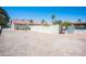Spacious backyard area with desert landscaping, block wall, and mature palm trees at 8340 W Fisher Ave, Las Vegas, NV 89149
