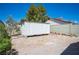 Backyard featuring a storage container, desert landscaping, and privacy wall at 8340 W Fisher Ave, Las Vegas, NV 89149