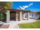 Backyard structure with stone accents, covered space, swing, and lush landscaping at 8340 W Fisher Ave, Las Vegas, NV 89149