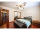 Bedroom with light walls, hardwood floors, mirrored closet doors, and ceiling fan at 8340 W Fisher Ave, Las Vegas, NV 89149