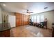 Bonus room with built in cabinets and shelving, with white refrigerator and shutters at 8340 W Fisher Ave, Las Vegas, NV 89149