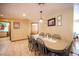 Dining area boasts a spacious table with seating for eight, complemented by tile flooring and natural light at 8340 W Fisher Ave, Las Vegas, NV 89149