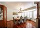 Elegant dining room with rich hardwood floors, stylish lighting, and a bay window offering natural light at 8340 W Fisher Ave, Las Vegas, NV 89149