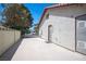 Side exterior view of home featuring a private access gate and covered patio at 8340 W Fisher Ave, Las Vegas, NV 89149