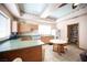 Kitchen with tile floors, breakfast bar, cabinets and view of the living room at 8340 W Fisher Ave, Las Vegas, NV 89149