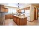 Spacious kitchen features a large island with granite countertops, wooden cabinets, and modern appliances at 8340 W Fisher Ave, Las Vegas, NV 89149