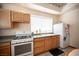 Bright kitchen with white appliances, wood cabinets, and a window over the sink at 8340 W Fisher Ave, Las Vegas, NV 89149