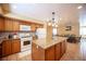 Bright kitchen features a large island, modern appliances, and seamless transition to the dining area at 8340 W Fisher Ave, Las Vegas, NV 89149