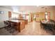 Spacious kitchen has oak cabinets, island with bar seating, white appliances and dining area at 8340 W Fisher Ave, Las Vegas, NV 89149