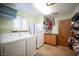 Laundry room with white washer and dryer and a built-in counter at 8340 W Fisher Ave, Las Vegas, NV 89149