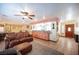 Open concept living room features a breakfast bar, tile floors, ceiling fan and leather furniture at 8340 W Fisher Ave, Las Vegas, NV 89149