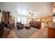 Expansive living room with wood burning fireplace, leather furniture and connecting kitchen at 8340 W Fisher Ave, Las Vegas, NV 89149