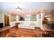 Spacious living room with hardwood floors and an open design leading to the kitchen and dining areas, ideal for entertaining at 8340 W Fisher Ave, Las Vegas, NV 89149