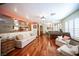 Bright living space with polished wood floors, large windows, and comfortable seating arrangement, perfect for relaxation at 8340 W Fisher Ave, Las Vegas, NV 89149