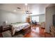 Spacious main bedroom with wood floors, a ceiling fan, and a dedicated office space with plantation shutters at 8340 W Fisher Ave, Las Vegas, NV 89149