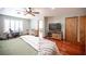 Well-lit bedroom boasts hardwood floors, neutral walls, and plenty of space for relaxation and work at 8340 W Fisher Ave, Las Vegas, NV 89149