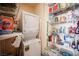 Organized pantry with shelving units, stackable washer/dryer, and storage for household items at 8340 W Fisher Ave, Las Vegas, NV 89149