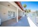 Covered patio featuring a swing, sliding glass doors and access gate to backyard at 8340 W Fisher Ave, Las Vegas, NV 89149