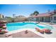 Backyard pool with rock features and a mature privacy hedge creating a relaxing backyard oasis at 8340 W Fisher Ave, Las Vegas, NV 89149