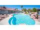 Beautiful backyard pool featuring rock accents, a perimeter concrete border, and backyard landscaping at 8340 W Fisher Ave, Las Vegas, NV 89149