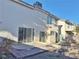 Home exterior with patio, sliding doors, and desert landscaping in the backyard at 8717 Harvest Valley Ave, Las Vegas, NV 89129