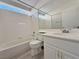 Bathroom featuring a tub-shower combination and a sink with white cabinets at 8717 Harvest Valley Ave, Las Vegas, NV 89129