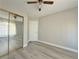 Bedroom featuring wood-look floors, neutral walls, a fan and closet, and a double electrical outlet at 8717 Harvest Valley Ave, Las Vegas, NV 89129