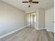 Bedroom featuring wood-look floors, neutral walls, a fan and closet, and a double electrical outlet at 8717 Harvest Valley Ave, Las Vegas, NV 89129