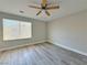 Bedroom featuring wood-look floors, a ceiling fan, and natural light from a window at 8717 Harvest Valley Ave, Las Vegas, NV 89129