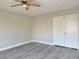 A spacious bedroom offers new vinyl floors, a ceiling fan, and a large wardrobe at 8717 Harvest Valley Ave, Las Vegas, NV 89129