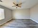 A spacious bedroom features new vinyl floors, a ceiling fan, and lots of light at 8717 Harvest Valley Ave, Las Vegas, NV 89129