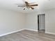 A bedroom with wood-look floors and a ceiling fan, offering a comfortable and stylish space at 8717 Harvest Valley Ave, Las Vegas, NV 89129