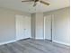 A spacious bedroom features new vinyl floors, a ceiling fan, and a double wardrobe at 8717 Harvest Valley Ave, Las Vegas, NV 89129