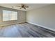 Bedroom with wood-look floors, neutral walls, a large window and ceiling fan at 8717 Harvest Valley Ave, Las Vegas, NV 89129