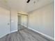 Bedroom featuring wood-look floors, neutral walls, a fan and closet, and a double electrical outlet at 8717 Harvest Valley Ave, Las Vegas, NV 89129