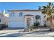 Charming two-story home featuring a desert-landscaped front yard and a white stucco exterior with red tile roof at 8717 Harvest Valley Ave, Las Vegas, NV 89129