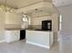 Spacious kitchen with white cabinets and granite countertops open to the dining area at 8717 Harvest Valley Ave, Las Vegas, NV 89129