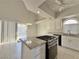 Open concept kitchen boasts granite countertops, island, and a sliding glass door at 8717 Harvest Valley Ave, Las Vegas, NV 89129